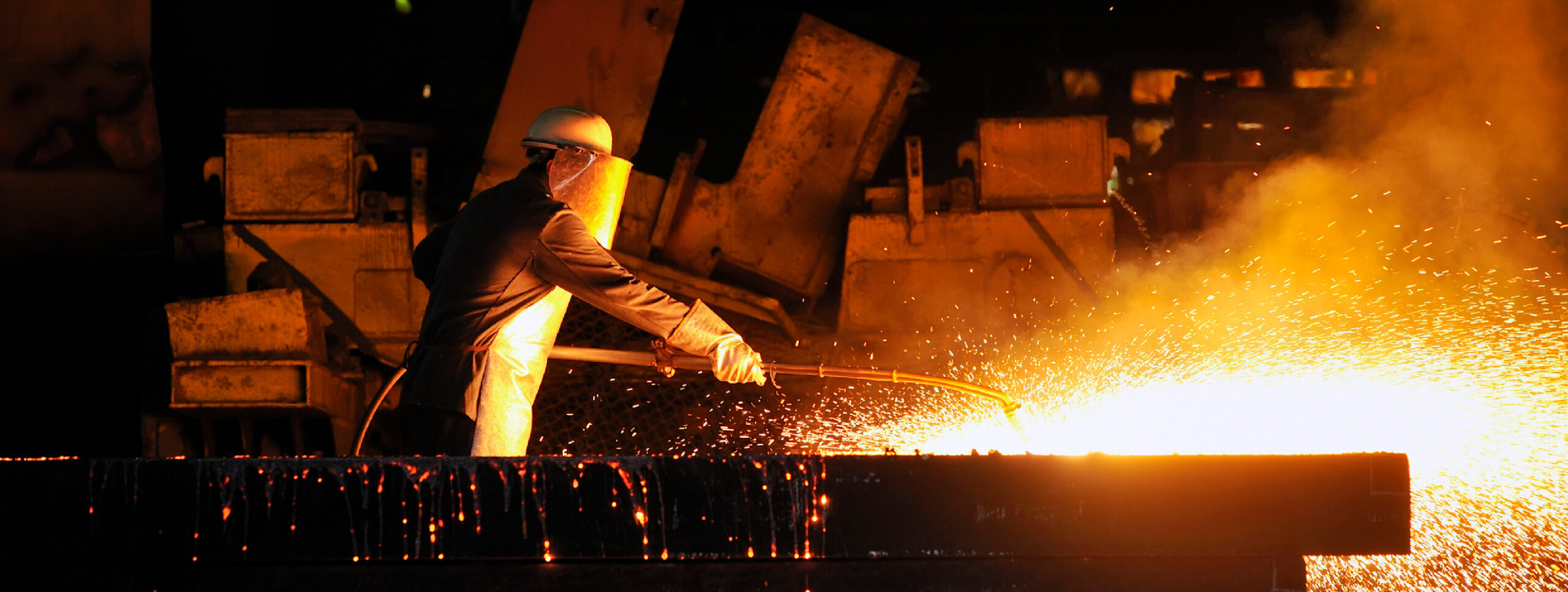 Man working with molten metal